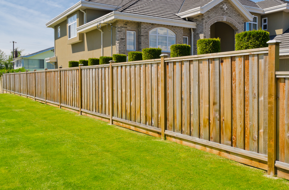 Fence with home behind it