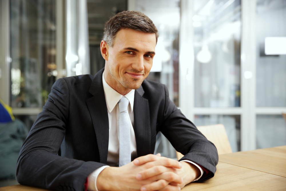 Real estate executive sitting at desk