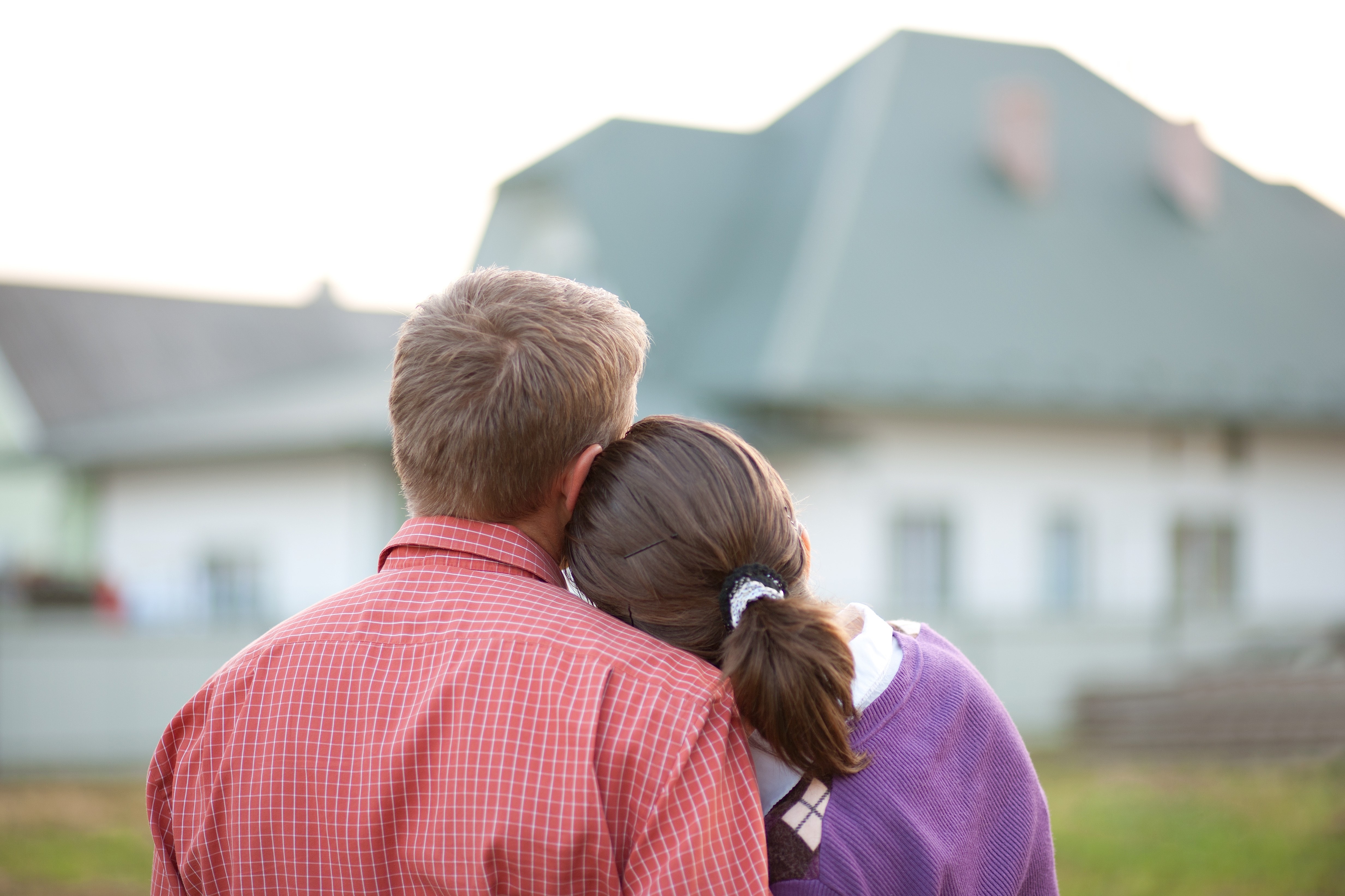 Couple in front of house.